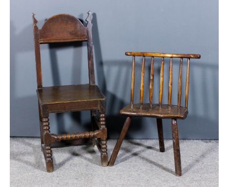 A 17th/18th Century primitive stick back low chair with wood seat on three legs, and a 19th Century oak chair with plain arch