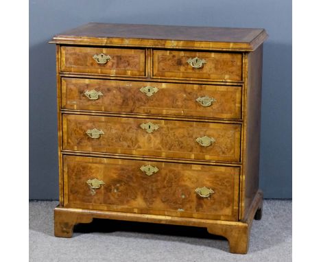 An old walnut chest of 18th Century design, the top quarter veneered in burr walnut and inlaid with concentric herringbone ba