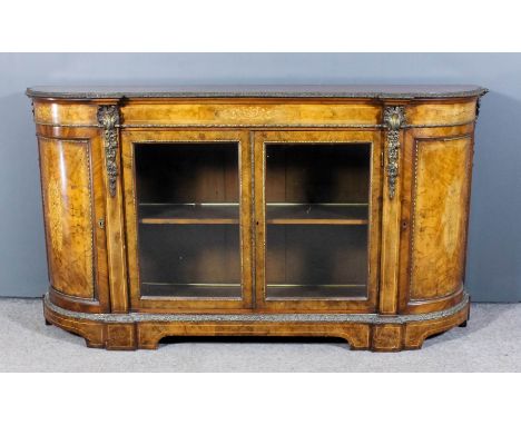 A Victorian figured walnut and gilt metal mounted credenza with bowed ends, the whole inlaid with stringings, the top crossba