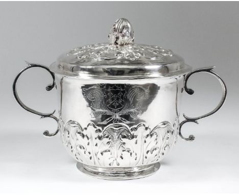 A James II silver two-handled cup and cover, the slightly domed cover with cast melon and leaf finial, boldly embossed and ch