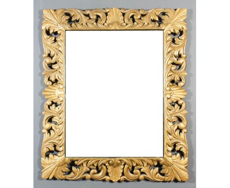 A gilt framed rectangular wall mirror, boldly fretted and carved with leaf scroll ornament and inset with bevelled mirror pan