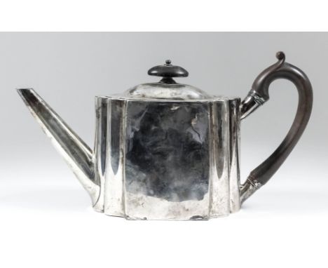 A George III plain silver oval tea pot with flattened sides and shaped ends, ebonised C-scroll handle and finial, 6.25ins hig