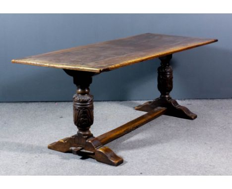 An oak refectory table of "17th Century" design with four plank pleated top, on heavy bulbous leaf carved end supports with t