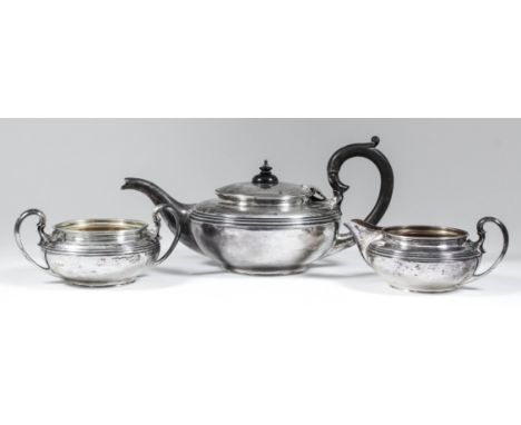 A George V silver circular three piece tea service of bulbous squat form with moulded rims and reeded bands to shoulder and w