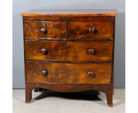 A late Georgian mahogany bow front chest with square edge to top, fitted two short and two long drawers, on shaped apron and 