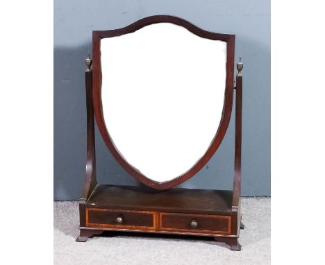 An Edwardian mahogany framed shield shaped toilet mirror in "George III" manner, inset with bevelled mirror plate, on tapered