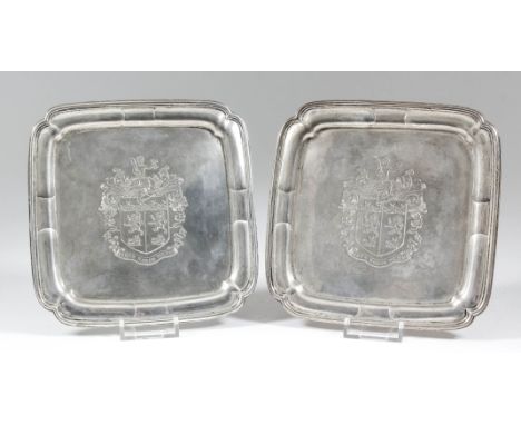 A pair of George V "Irish" cast silver square waiters of early 18th Century design with moulded rims, the centre engraved wit