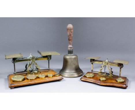 A set of late 19th Century brass letter scales and weights on oak base, 10.75ins x 6ins x 5.5ins high, another set on walnut 