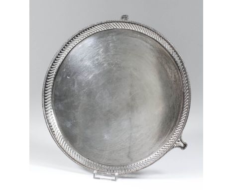 A George V silver circular salver with rope pattern rim, pierced border and on three pierced panel feet, 9.125ins diameter, b
