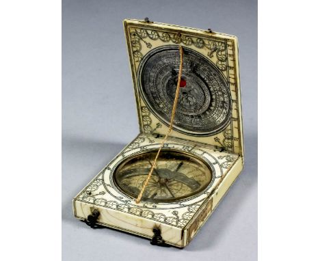 A good 17th/18th Century Continental ivory and silvery metal folding pocket compass, the paper scale inset with silvery metal