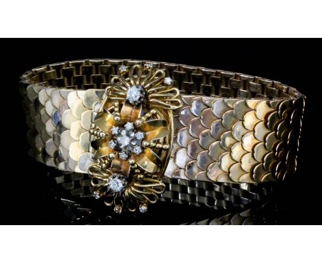 An unusual lady's 14ct gold fish scale diamond set bracelet with concealed cabochon wrist watch, the white enamel face concea