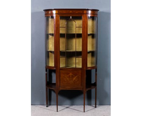 An Edwardian mahogany breakfront display cabinet, the whole inlaid with stringings, with moulded cornice, frieze inlaid with 