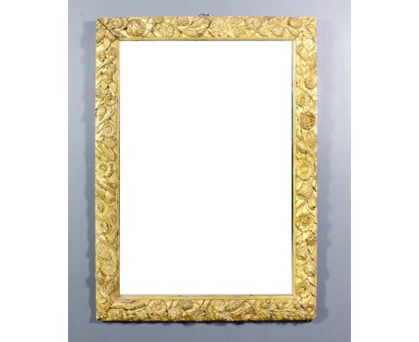 A 19th Century gilt framed rectangular wall mirror, boldly carved with flowers and leaves and bead ornament and inset with be