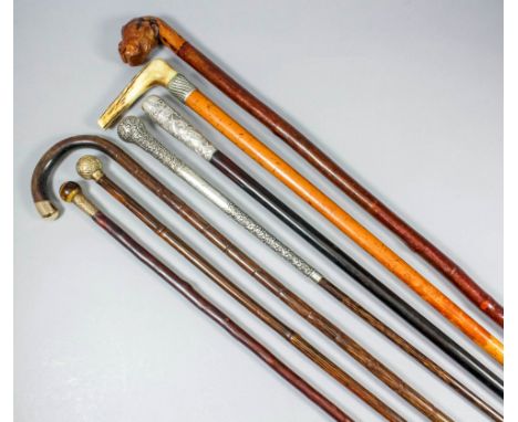 A late 19th/early 20th Century gold plated mounted walking cane with topaz finial and briar shaft, 35ins, two gold coloured m