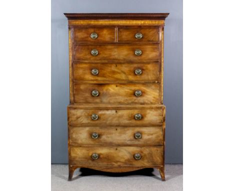 A George III mahogany tallboy, the upper part with moulded and dentil cornice, the frieze and canted front corners inlaid wit