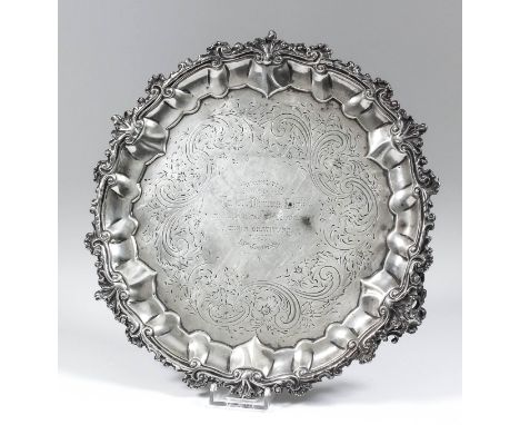 An early Victorian silver circular salver, the shaped and moulded rim cast with scroll and shell ornament, the centre engrave