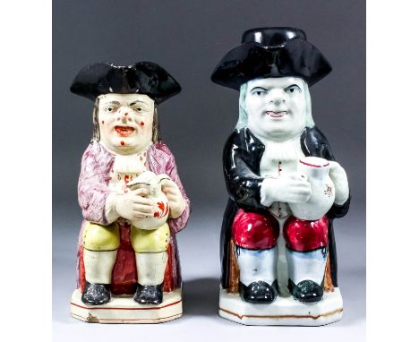 A 19th Century Staffordshire pottery Toby jug of traditional form with warty face, holding a jug of foaming ale, his jacket s