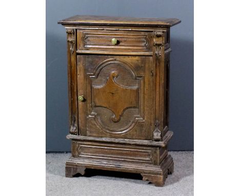 An Italian walnut side cabinet with moulded edge to top, fitted one frieze drawer, cupboard under enclosed by a shaped and mo