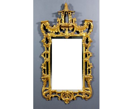 A gilt framed rectangular wall mirror of "Chinese Chippendale" design with pagoda pattern cresting, the frame fretted and car