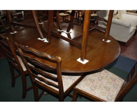 A Georgian style mahogany twin pedestal dining table, set of eight ladder back dining chairs and a bowfront mahogany sideboar