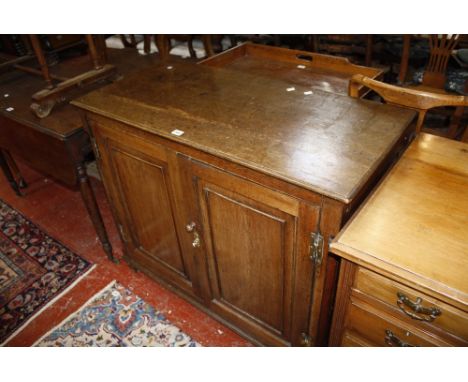 A 19th Century oak cupboard with twin fielded panel doors enclosing drawers and a shelf 106cm wide