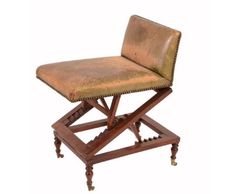 A Victorian mahogany and studded leather upholstered adjustable stool, circa 1860, usually termed a ' gout stool', the rectan