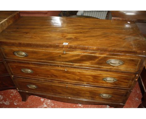 A George IV mahogany veneered commode of three long drawers, 118cm long, 87cm high.
