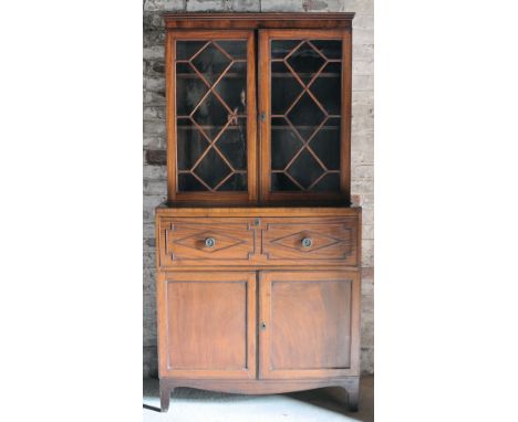 An early 19th Century mahogany Secretaire Bookcase, the upper section enclosed by a pair of glazed tracery doors, full front 