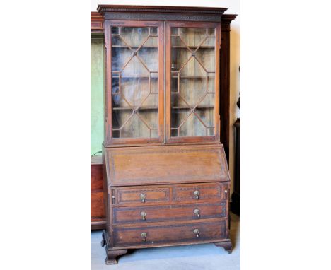 A Georgian design mahogany Bureau Bookcase, the upper section enclosed by glazed tracery doors, hinged fall under with two lo