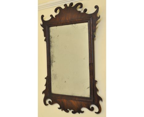 A 19th Century upright Wall Mirror of Chippendale design in fret carved mahogany frame.  28" (71cms) x 18" (46cms). 
