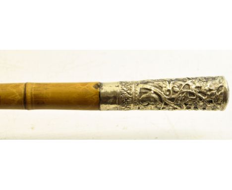A bamboo Walking Stick with Eastern white metal mounts. 