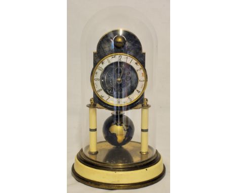 A 365 day Clock, the dial decorated with zodiac signs, pendulum formed as a globe and under a glass dome shade. 