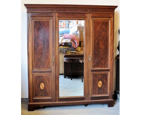 An Edwardian mahogany Wardrobe inlaid with satinwood banding and faux dentil cornice, the interior fitted for hanging and wit