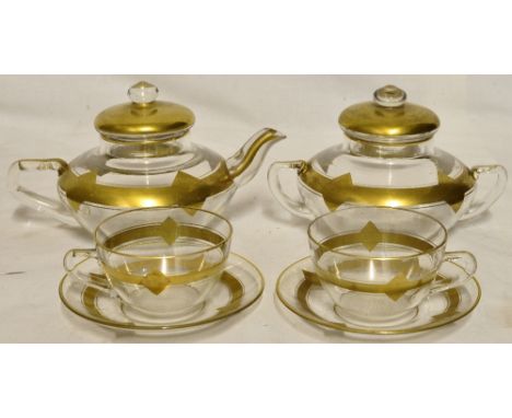 An early Pyrex part Teaset decorated in gilt, comprising teapot, two handled sugar bowl and cover, and two cups and saucers. 