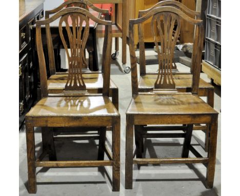 A set of four oak and elm Country Chippendale design Dining Chairs with pierced splat backs, panel seats and square supports.