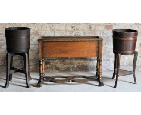 A pair of oak brass banded Jardinieres by Lister & Co of Gloucestershire, on shaped floor stands, and an oak oblong Planter o