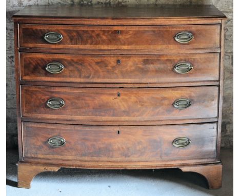 An early 19th Century mahogany bow fronted Chest with moulded edge, fitted with four long graduated drawers with oval brass h