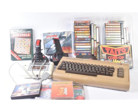 Retro Gaming - a vintage Commodore 64 home computer with keyboard, tape drive, joysticks and assorted cassette games. Games c