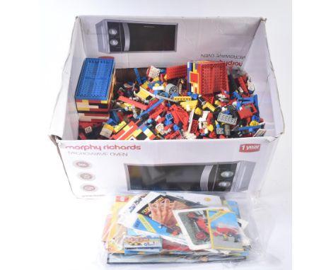 A collection of assorted vintage Lego loose bricks of various sizes and a selection of instruction booklets. Set manuals to i