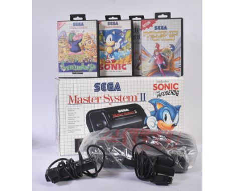 Retro Gaming - a vintage boxed Sega Master System II console with x4 gaming cartridges. The console with x2 controllers, inst