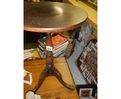 A small round tripod table