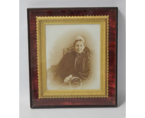AN ANTIQUE GILT PICTURE FRAME WITH RED VELVET SURROUND, set behind glass displaying a photographic portrait signed in pencil,