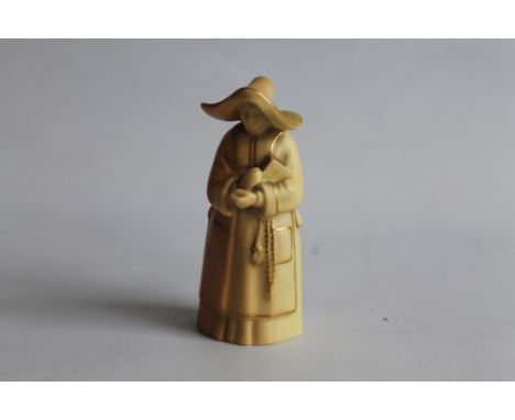 A ROYAL WORCESTER CANDLE SNUFFER, in the form of a nun, in blush ivory. H.9.5 cm