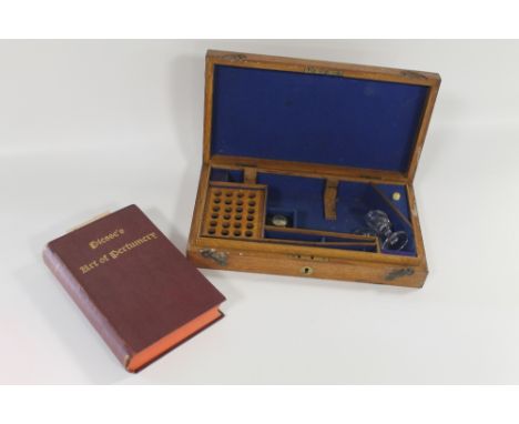 A PERFUMER'S WOODEN BOX WITH PART CONTENTS and a copy of 'Piesse's Art of Perfumery', 5th Edition 1891