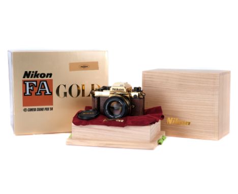 A Nikon FA Gold 'Grand Prix '84' SLR Camera, 1984, gold, serial no. 2006023, with Nikon Ais Nikkor f/1.4 50mm lens, black/gol