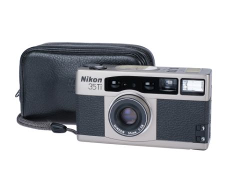 A Nikon 35Ti Compact Camera, 1993, titanium, serial no. 5009788, with Nikon f/2.8 35mm lens, body, VG, powers up and appears 