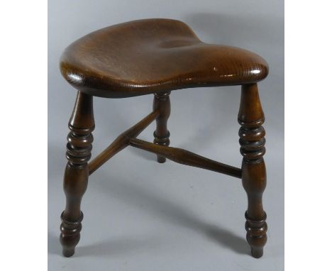 A Carved Wooden Shaped Topped Stool on Turned Tripod Supports, 47cm high 