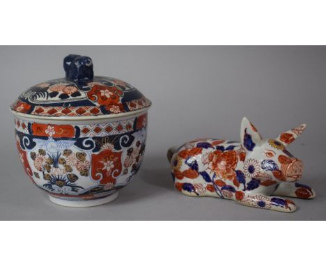 A 20th Century Oriental Lidded Bowl in the Imari Pallette With Dragon Finial to Lid Together with a Ceramic Study of a Recumb