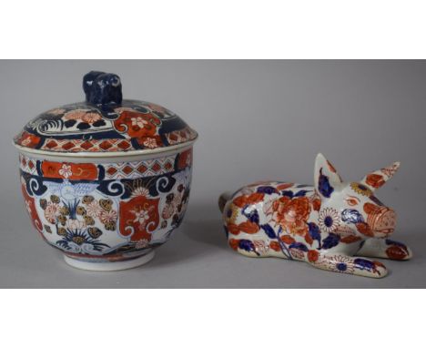 A 20th Century Oriental Lidded Bowl in the Imari Pallette With Dragon Finial to Lid Together with a Ceramic Study of a Recumb