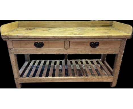 Farmhouse pine preparation table, the gallery surface above two drawers, raised on square block legs, with supporting lower l
